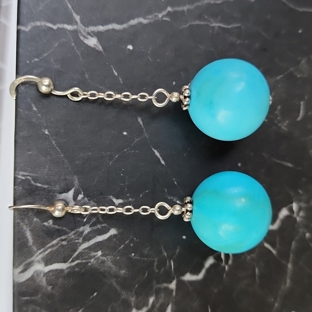 Sterling silver and genuine turquoise stone earrings.